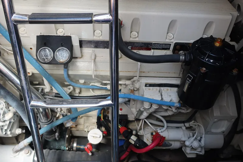 Slide: The Image of Engine compartment of a 2005 Sea Ray 500 Sundancer boat, showing gauges and hoses. - 10