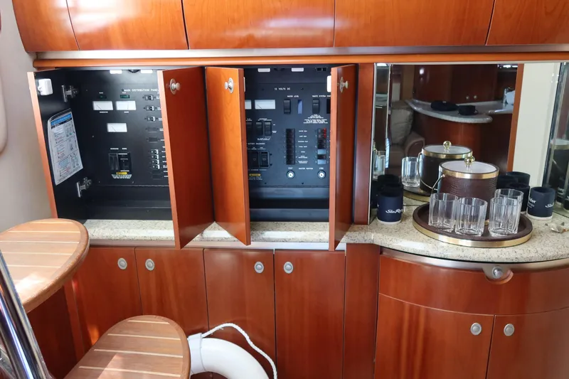 Slide: The Image of Interior of 2005 Sea Ray 500 Sundancer with control panels and bar setup. - 15