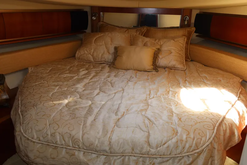 Slide: The Image of Luxurious cabin interior of 2005 Sea Ray 500 Sundancer with plush bedding. - 18