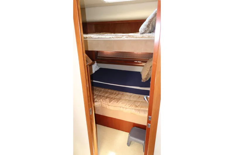 Slide: The Image of Bunk beds in 2005 Sea Ray 500 Sundancer yacht cabin, featuring wooden finishes and cozy bedding. - 20