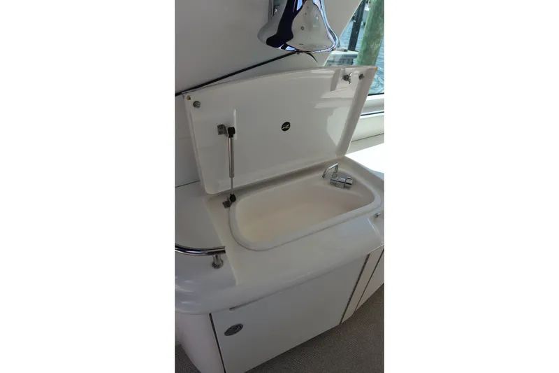 Slide: The Image of 2005 Sea Ray 500 Sundancer yacht sink with open lid and faucet. - 8
