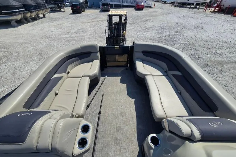 Slide: The Image of Interior view of 2022 Barletta C22UC pontoon boat with spacious seating and cup holders. - 5