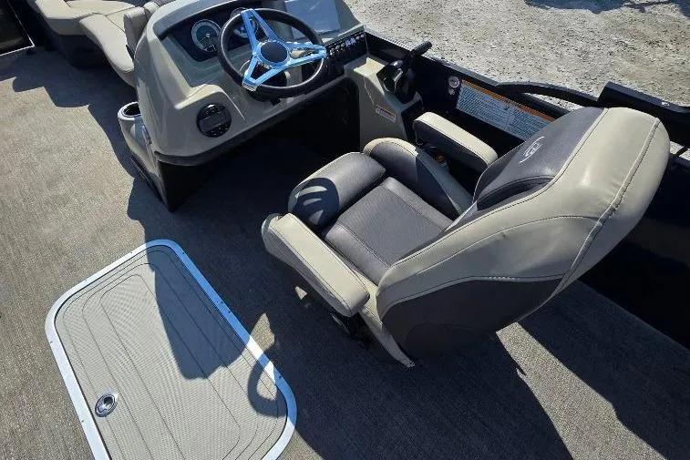 Slide: The Image of 2022 Barletta C22UC boat interior with steering wheel and captain's chair. - 7