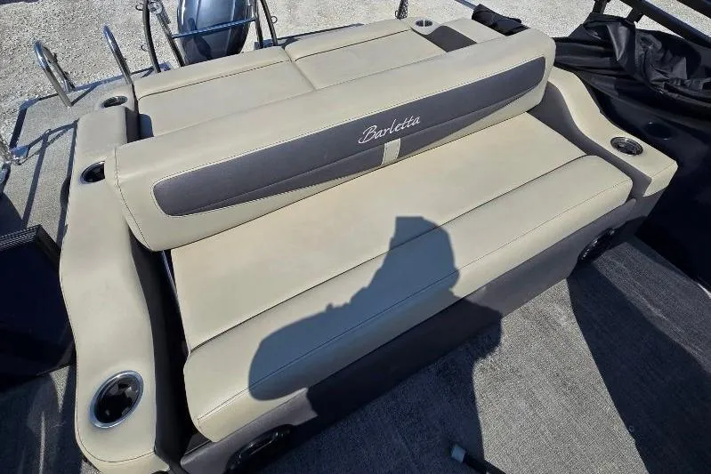 Slide: The Image of 2022 Barletta C22UC boat seating with beige upholstery and integrated cup holders. - 8
