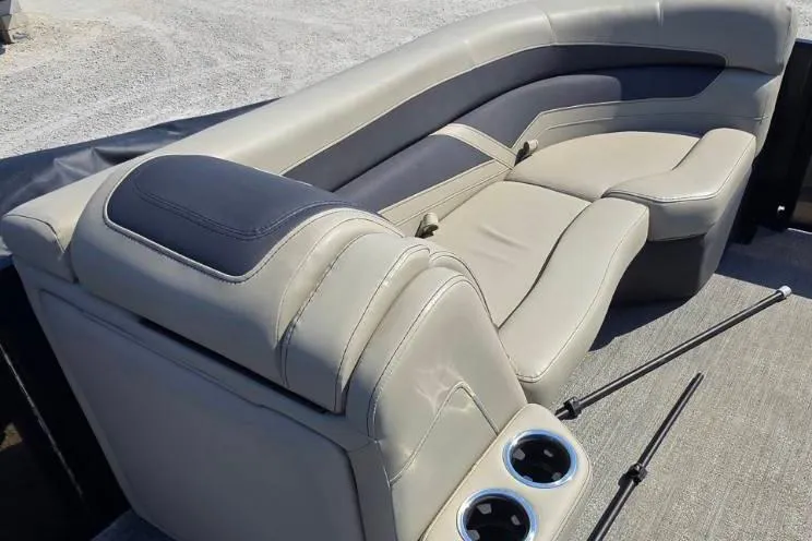 Slide: The Image of 2022 Barletta C22UC boat interior with beige seating and cup holders. - 9