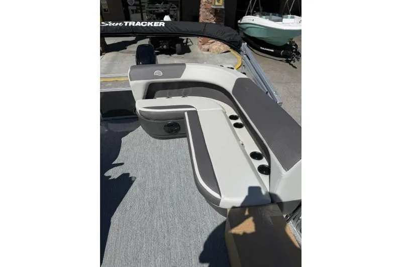 Slide: The Image of 2026 Sun Tracker Bass Buggy 16 XL Select boat interior with cushioned seating and cup holders. - 8