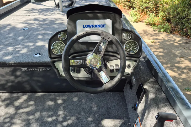 Slide: The Image of 2026 Ranger RT188 boat dashboard with steering wheel and Lowrance electronics. - 9