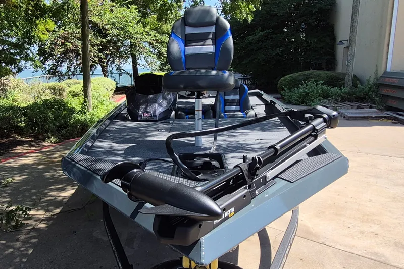 Slide: The Image of 2026 Ranger RT188 fishing boat with trolling motor and swivel seat, parked outdoors. - 2