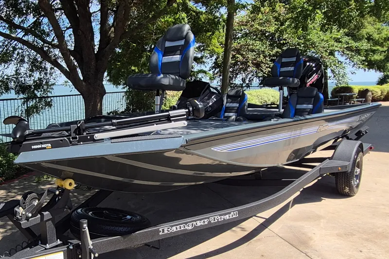 Slide: The Image of 2026 Ranger RT188 fishing boat on trailer, parked near a scenic lakeside. - 1