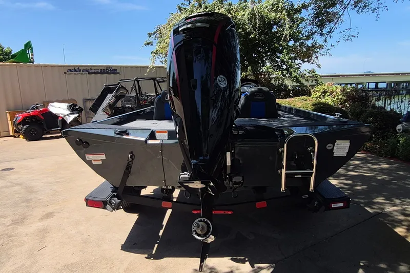 Slide: The Image of 2026 Ranger RT188 boat with outboard motor, parked outdoors on a sunny day. - 5