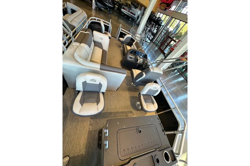 Slide: The Image of 2026 Sun Tracker Fishin' Barge 20 DLX interior with seating and control console. - 4