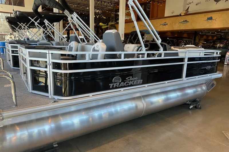 Slide: The Image of 2026 Sun Tracker Fishin' Barge 20 DLX pontoon boat displayed indoors. - 2