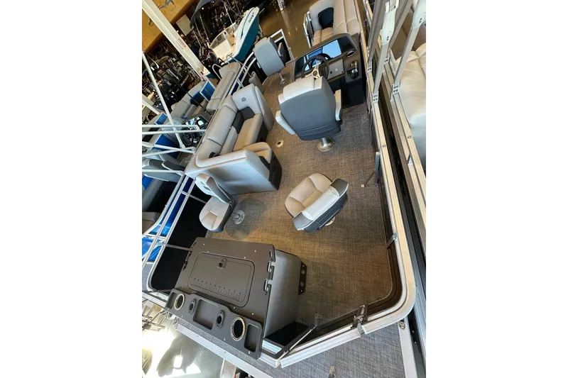 Slide: The Image of 2026 Sun Tracker Fishin' Barge 20 DLX interior with seating and helm station. - 7