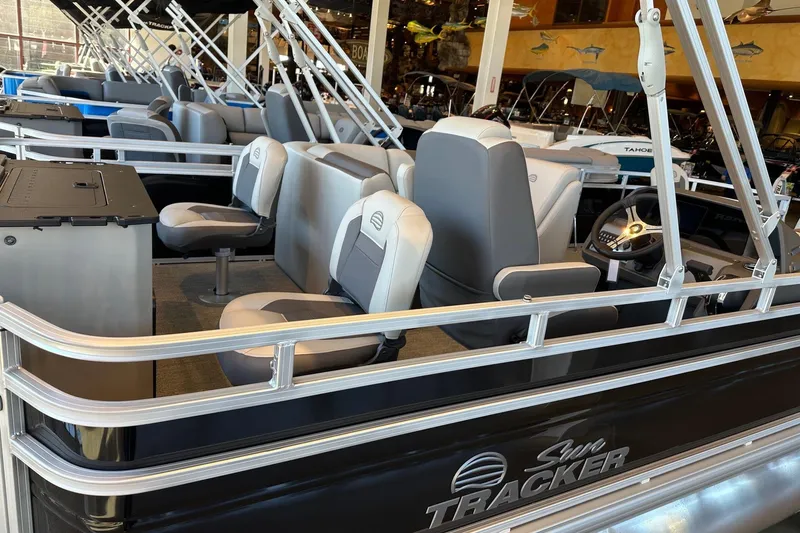 Slide: The Image of 2026 Sun Tracker Fishin' Barge 20 DLX interior with seating and steering console. - 5