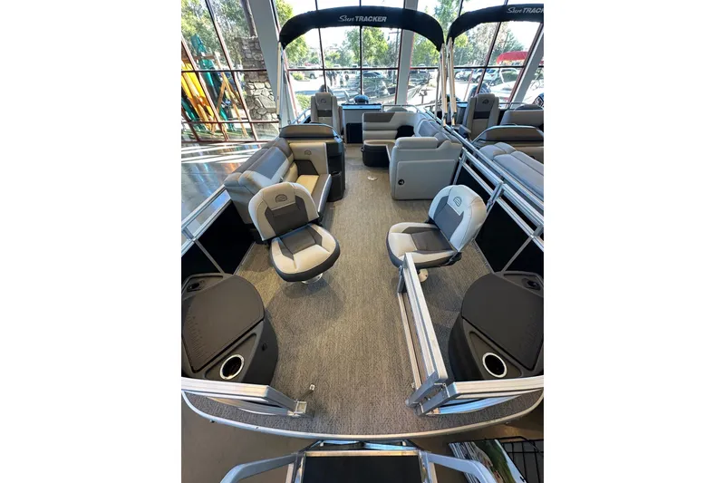 Slide: The Image of 2026 Sun Tracker Fishin' Barge 20 DLX interior with seating and fishing amenities. - 6