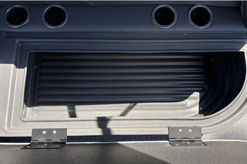 Slide: The Image of Storage compartment on 2026 Sun Tracker Party Barge 16 DLX with cup holders. - 23