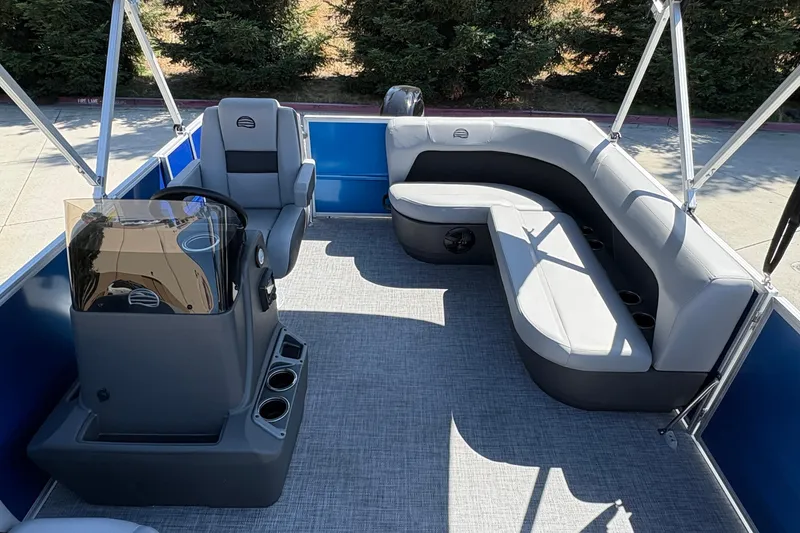 Slide: The Image of 2026 Sun Tracker Party Barge 16 DLX interior with seating and helm station. - 17