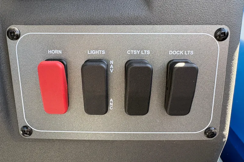 Slide: The Image of Control panel of 2026 Sun Tracker Party Barge 16 DLX with switches for horn and lights. - 30
