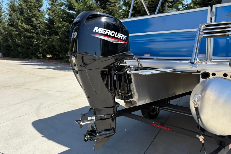 Slide: The Image of 2026 Sun Tracker Party Barge 16 DLX with Mercury outboard motor in a sunny outdoor setting. - 12