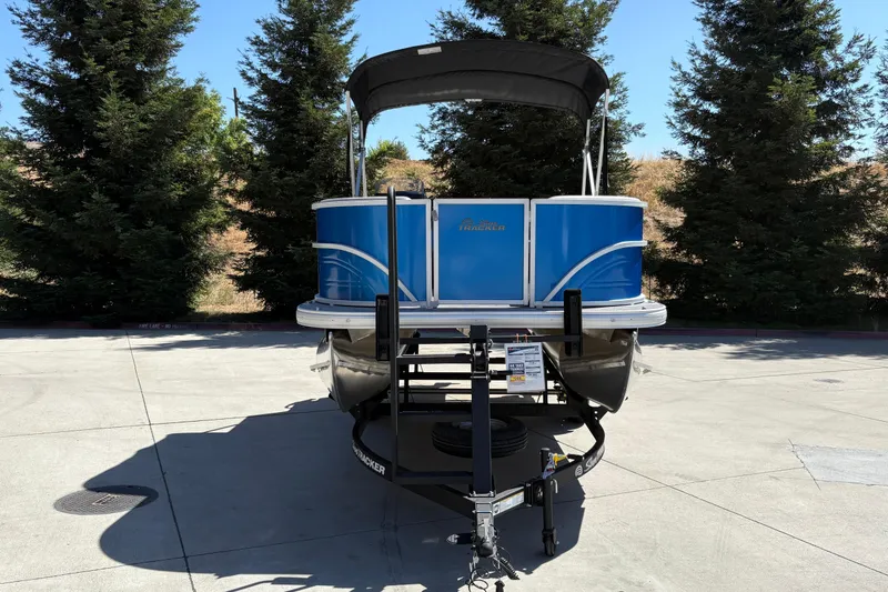 Slide: The Image of 2026 Sun Tracker Party Barge 16 DLX pontoon boat on trailer, parked outdoors. - 6