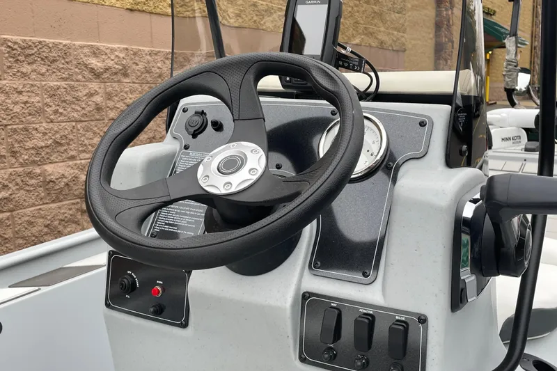 Slide: The Image of Steering console of 2026 Tracker Bass Tracker Classic CC boat with controls and gauges. - 6