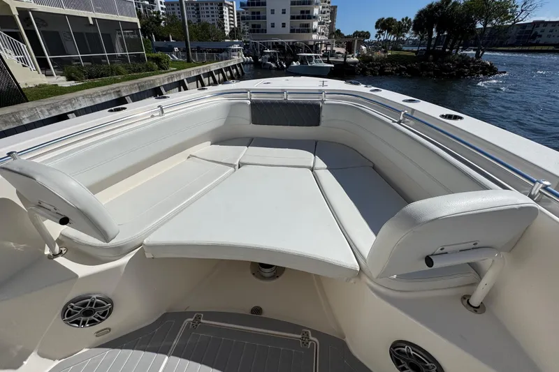 Slide: The Image of 2023 Cobia 280 Center Console boat with spacious seating and waterfront view. - 17