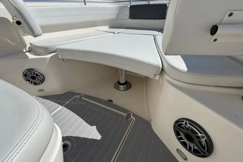 Slide: The Image of 2023 Cobia 280 Center Console boat interior with cushioned seating and speakers. - 18