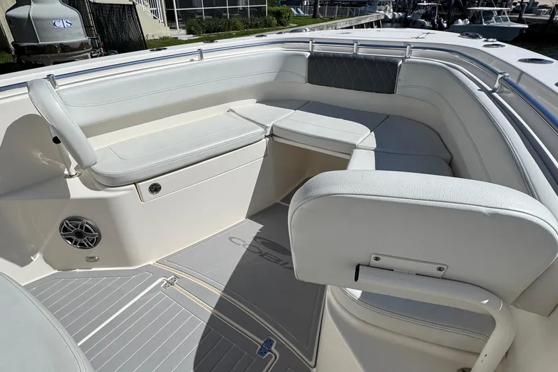 Slide: The Image of 2023 Cobia 280 Center Console boat interior with white seating and speaker. - 21