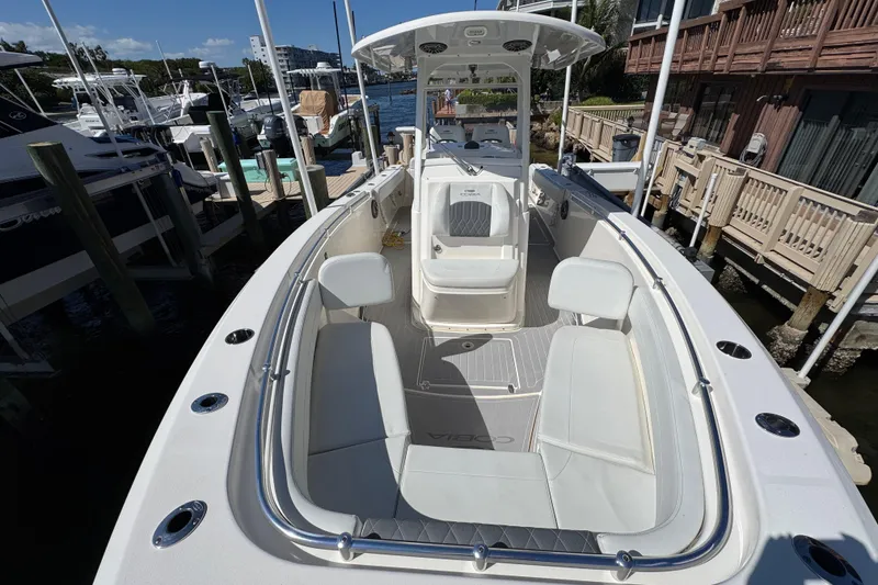 Slide: The Image of 2023 Cobia 280 Center Console boat docked, featuring spacious seating and sleek design. - 24