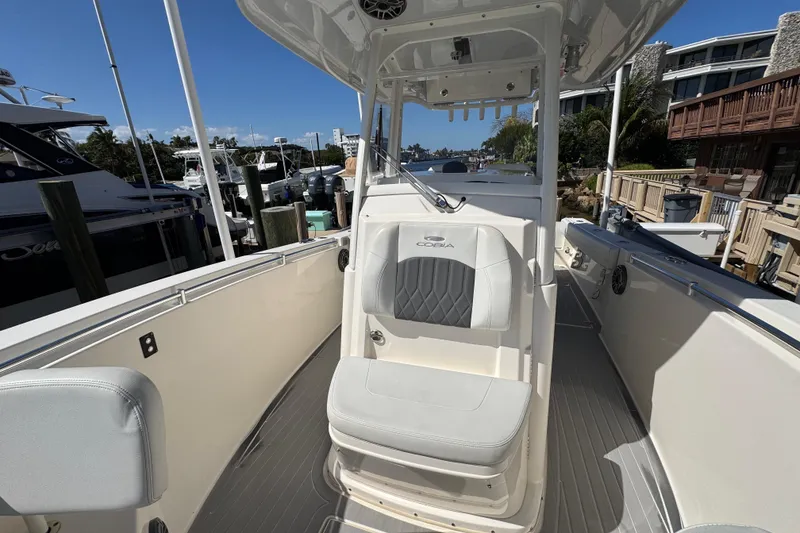 Slide: The Image of 2023 Cobia 280 Center Console boat interior with seating and console view. - 26