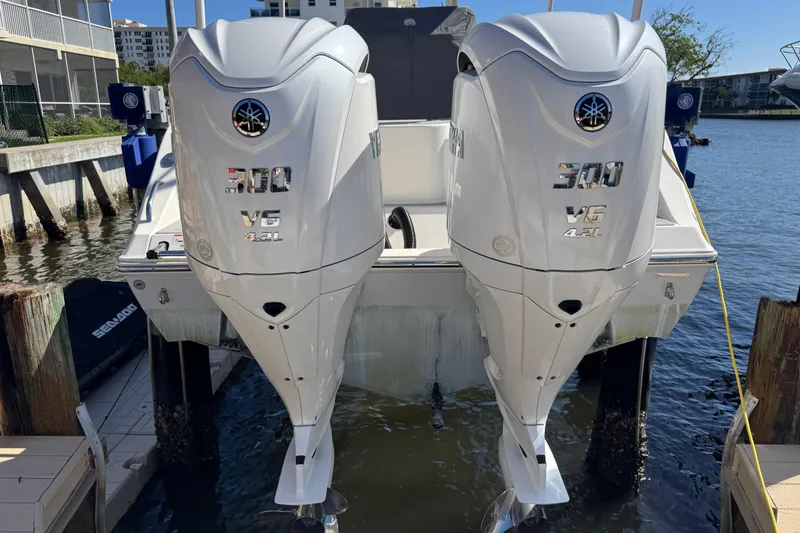 Slide: The Image of 2023 Cobia 280 Center Console with twin Yamaha 300 V6 outboard engines docked. - 6