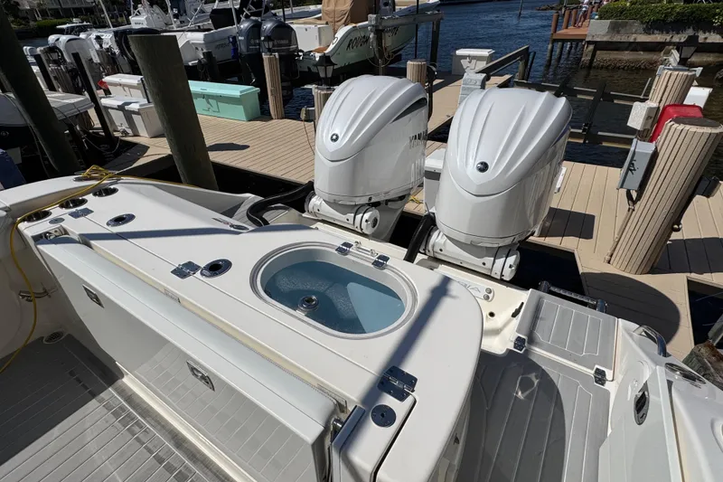 Slide: The Image of 2023 Cobia 280 Center Console boat with dual engines docked at marina. - 8