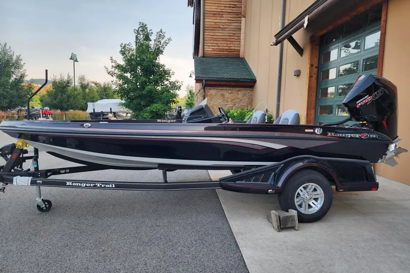The Image of 2026 Ranger Z518 boat on trailer, parked outdoors near a building. - 0