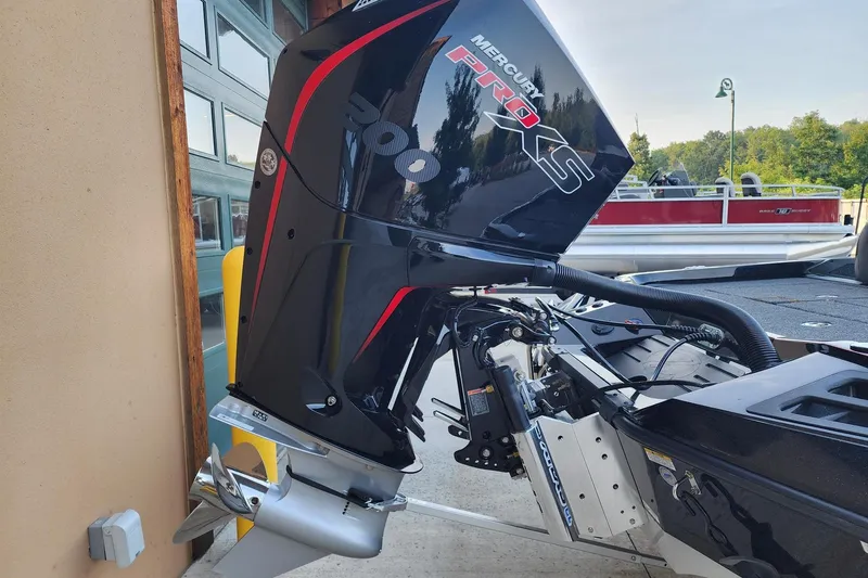 Slide: The Image of 2026 Ranger Z518 boat with Mercury Pro XS outboard motor, docked near a building. - 5