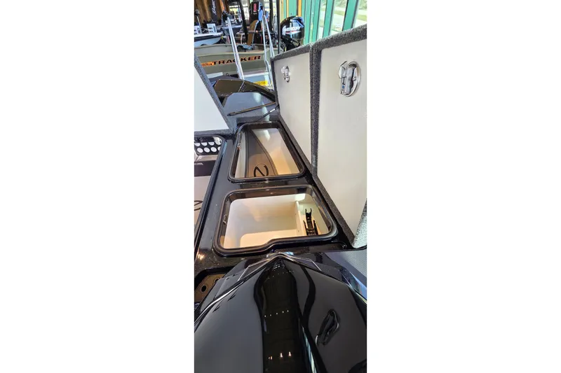 Slide: The Image of Open storage compartments on a 2026 Ranger Z518 boat. - 18