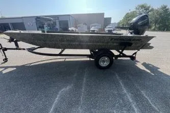 Slide: The Image of 2026 Tracker Grizzly 1654 T Sportsman boat on trailer in parking lot. - 43