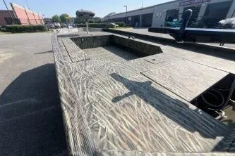 Slide: The Image of 2026 Tracker Grizzly 1654 T Sportsman boat with camouflage design in outdoor setting. - 42