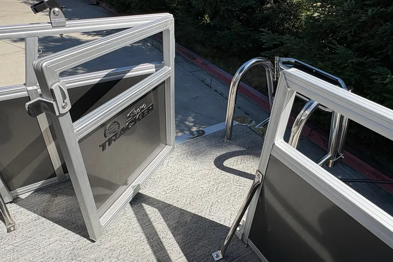 Slide: The Image of 2026 Sun Tracker Bass Buggy 16 XL Select pontoon boat with open gate and ladder. - 17
