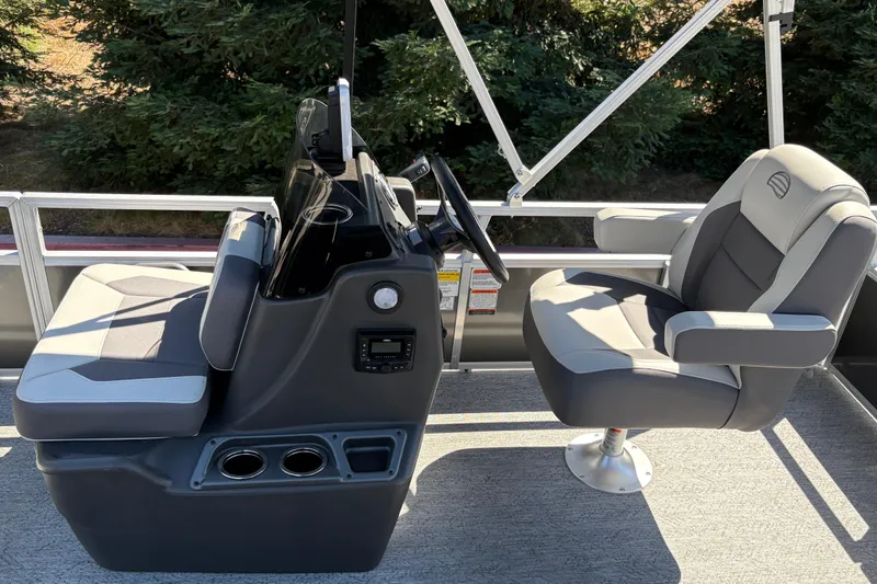 Slide: The Image of 2026 Sun Tracker Bass Buggy 16 XL Select pontoon boat interior with helm and seating. - 9