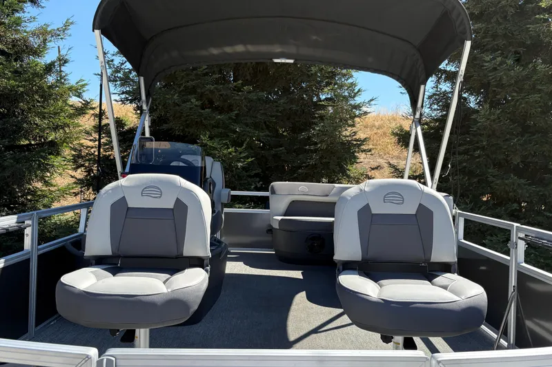 Slide: The Image of 2026 Sun Tracker Bass Buggy 16 XL Select pontoon boat interior with seating and canopy. - 6
