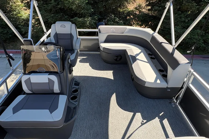 Slide: The Image of 2026 Sun Tracker Bass Buggy 16 XL Select pontoon boat interior with seating and console. - 5