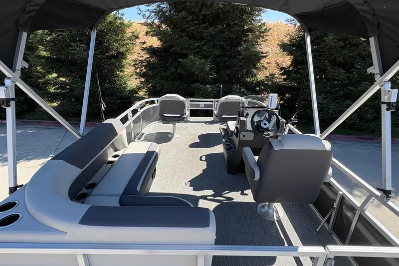 Slide: The Image of 2026 Sun Tracker Bass Buggy 16 XL Select pontoon boat interior with seating and steering console. - 10