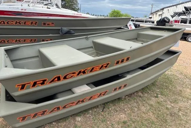 The Image of 2026 Tracker Grizzly 10 Jon boats stacked outdoors at a dealership. - 0
