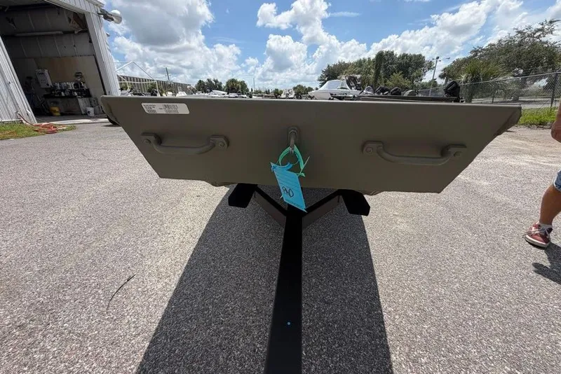 Slide: The Image of 2026 Tracker Grizzly 10 Jon boat on trailer under a cloudy sky. - 33