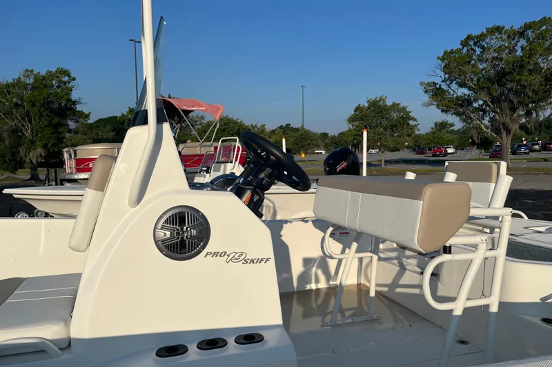 Slide: The Image of 2026 Mako Pro Skiff 19 CC boat interior with steering wheel and seating. - 5