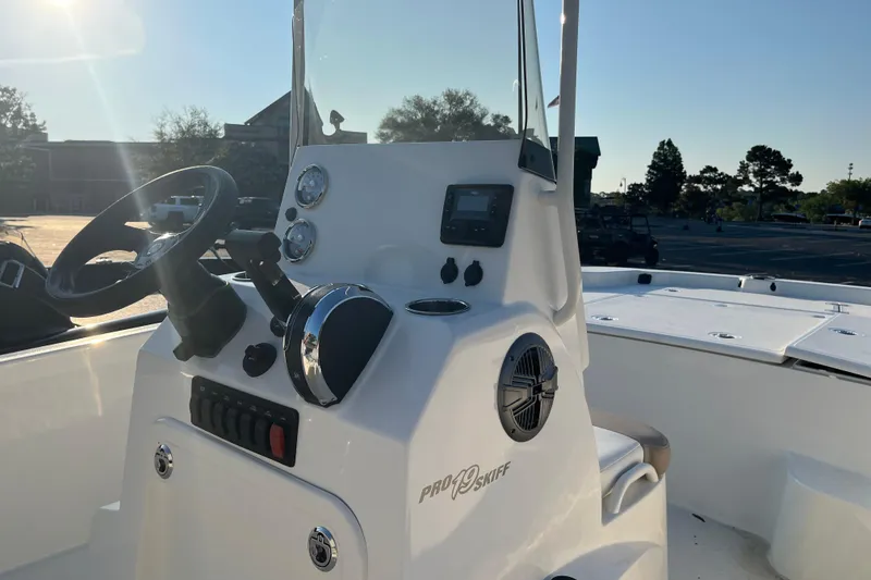 Slide: The Image of 2026 Mako Pro Skiff 19 CC boat console with steering wheel and controls. - 6