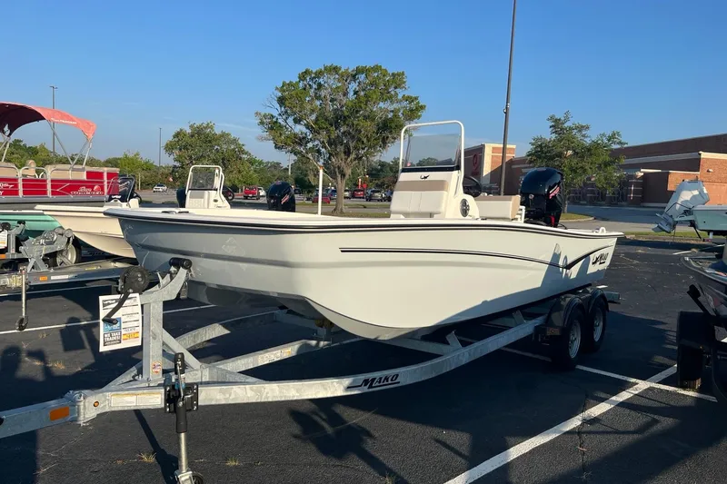 Slide: The Image of 2026 Mako Pro Skiff 19 CC boat on trailer in parking lot. - 1