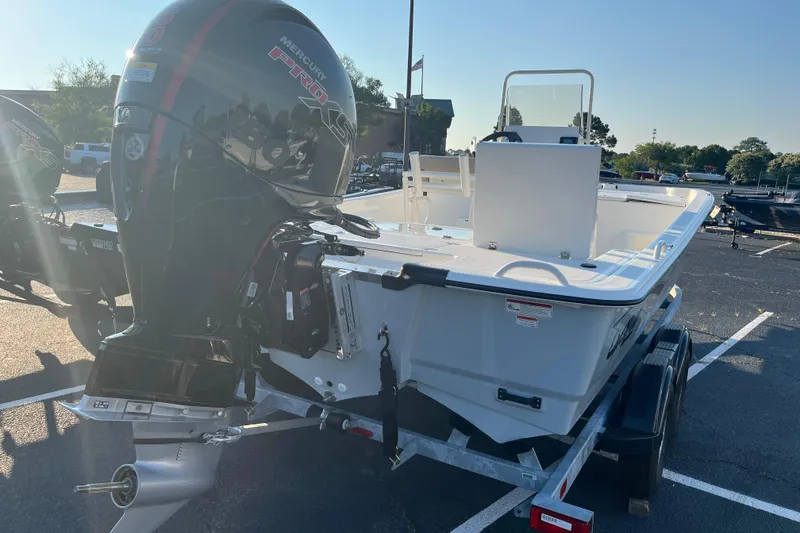 Slide: The Image of 2026 Mako Pro Skiff 19 CC boat with Mercury engine on trailer in parking lot. - 7