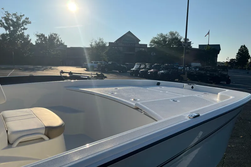 Slide: The Image of 2026 Mako Pro Skiff 19 CC boat in a parking lot at sunset. - 4