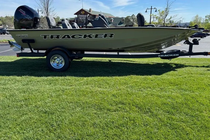 The Image of 2026 Tracker Pro Team 195 boat on trailer, parked on grass. - 0